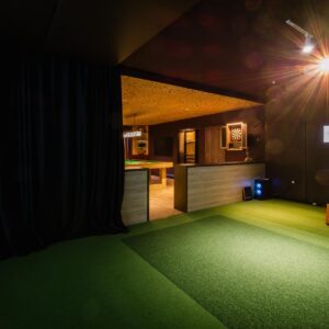 The view of the golf simulator within a luxury games room.