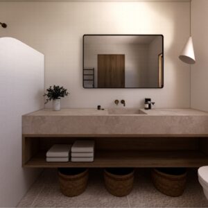 Atmospheric 3D render of a Menorcan villa bathroom with a floating timber vanity, stone countertop and integrated basin, brass wall tap, arched shower niche with rainfall shower head, rectangular mirror, pendant light, and wall-hung toilet.