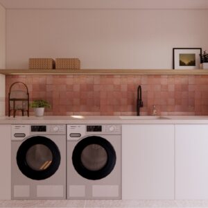 Warm 3D render of a Menorcan villa utility room with white cabinetry, twin front-loading washers, a stone countertop with integrated sink and black tap, terracotta tile splashback, and timber shelf styling.