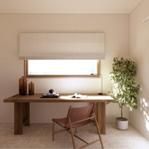 Sunlit 3D render set within a Menorcan villa, showing a minimalist home office nook with a solid timber desk beneath a wide horizontal window with a white roman blind, a leather sling chair, small floating shelves, a slim black task lamp, and a potted indoor tree beside a tall glazed opening with sheer curtains.