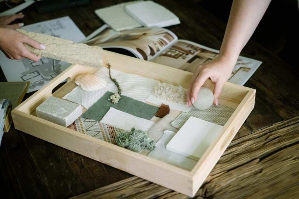 Property renovation in Menorca material palette tray with natural fabrics, stone, shell, timber and textured samples for a regenerative interior scheme.