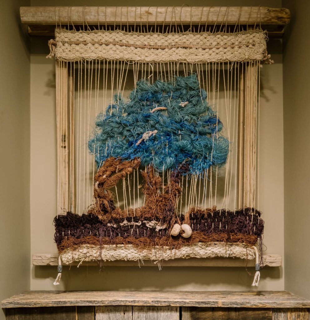 Woven artwork by Magda Triay made from discarded fishing nets, bringing texture, sustainability and a strong connection to Menorca’s maritime landscape.